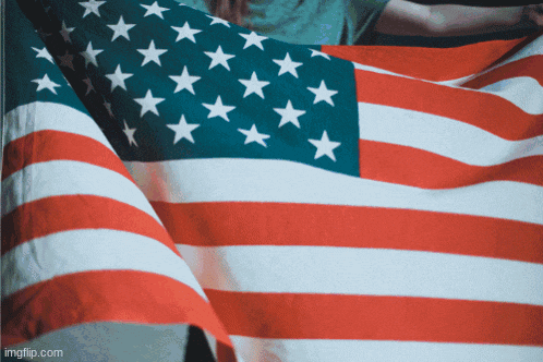 a person is holding a large american flag with imgflip.com at the bottom of the image
