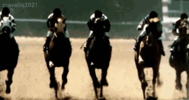 a group of horses are racing on a track and the year 2021 is visible