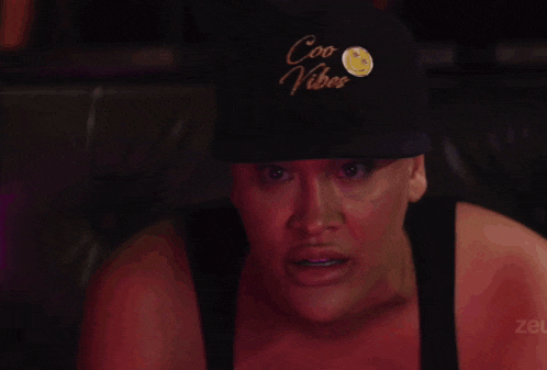 a woman wearing a hat that says coo vibe