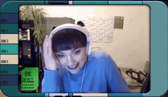 a woman wearing headphones is smiling in front of a screen that says re roll on it