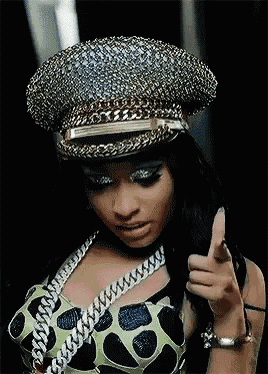 a woman is wearing a hat and giving a thumbs up sign