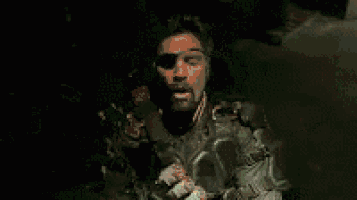 a close up of a person wearing a mask and holding a gun