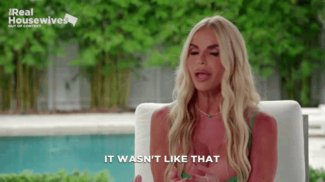 a woman is sitting in front of a pool and says it wasn 't like that ..
