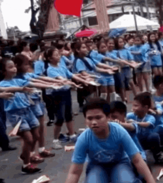 a group of people wearing blue shirts with the word philippines on the front