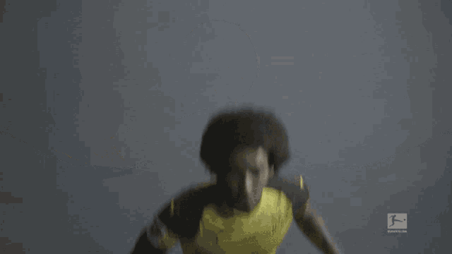 a soccer player wearing a yellow and black evon jersey