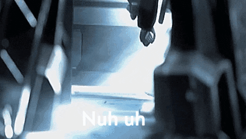 a dark room with the words nuh uh written on the bottom