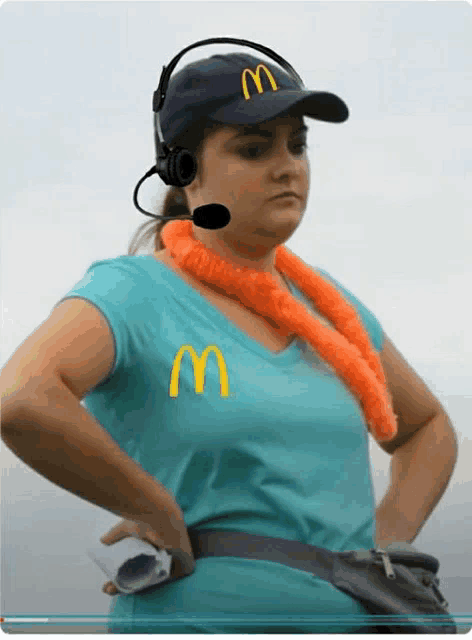 a woman wearing headphones and a mcdonald 's hat