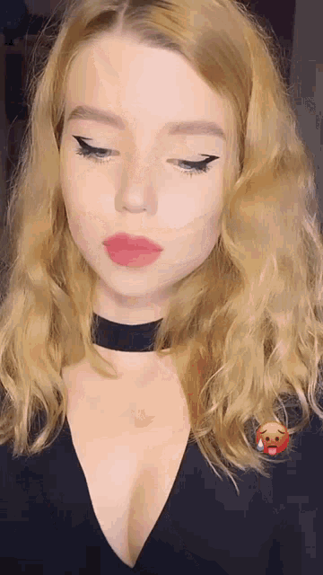 a woman with blonde hair wearing a black choker and red lipstick