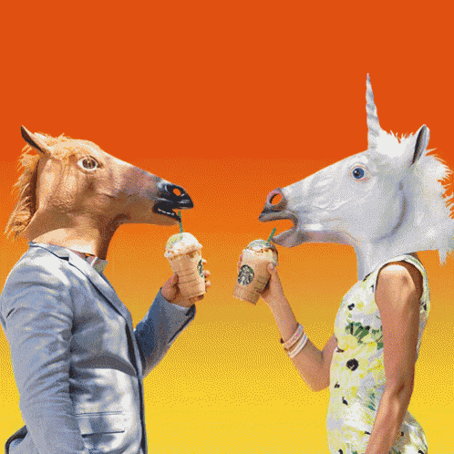 a man and a woman wearing horse masks are toasting with starbucks coffee