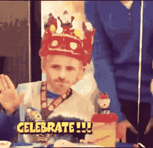 a man with a crown on his head says celebrate !!!