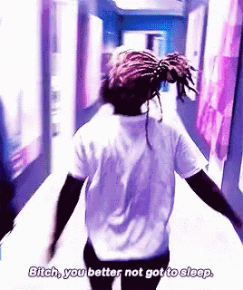 a man with dreadlocks is walking down a hallway and saying bitch you better not got to sleep .