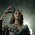 a woman in a fur coat is holding a crown over her head .