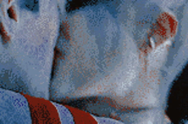 a pixelated image of a person 's face with a red ear