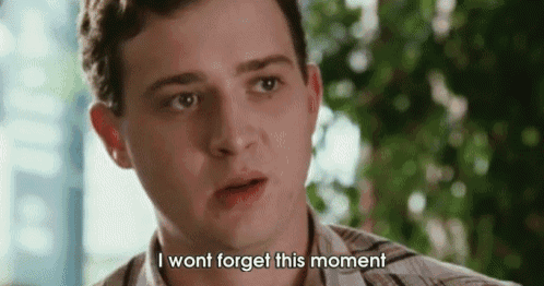 a close up of a man 's face with the words `` i wont forget this moment '' .