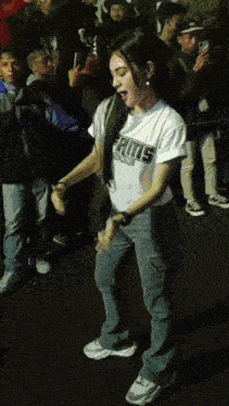 a girl wearing a shirt that says ' rams ' on it is dancing