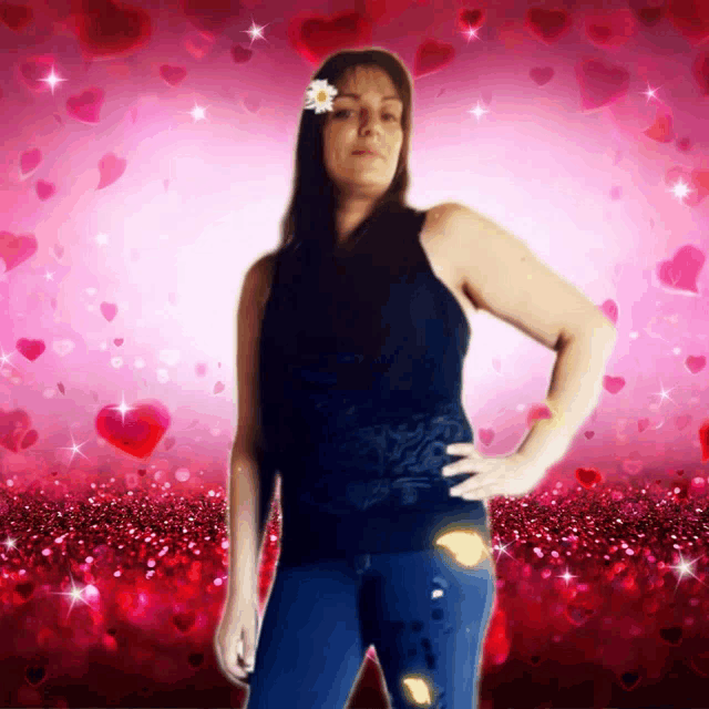 a woman with a flower in her hair stands in front of a background of hearts