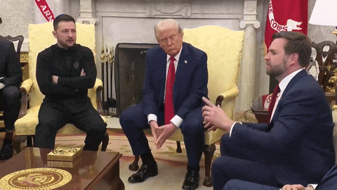 a group of men are sitting around a table with a coin on it that says " united states "