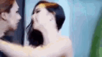 two women are hugging each other and looking at each other .