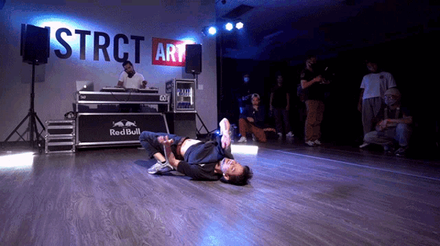 a man laying on the floor in front of a sign that says strict art