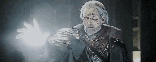 a man with white hair and a beard is holding a light in his hand .