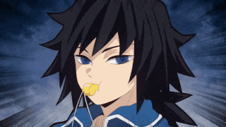 a boy with long black hair is blowing a yellow whistle