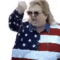 a man is wearing an american flag shirt and sunglasses .