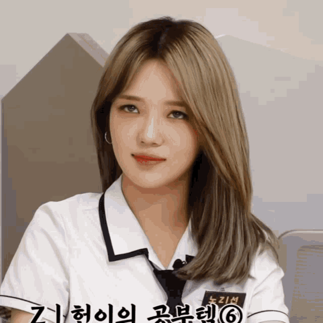a girl in a school uniform has the number 6 on her chest