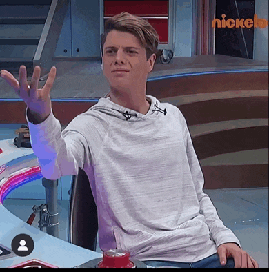a man sitting in a chair with a nickelodeon logo in the background
