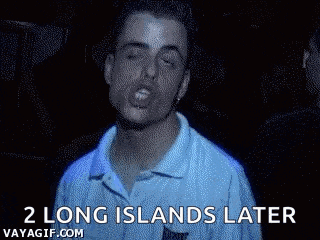 a man is singing in a dark room with the words `` 2 long islands later '' .