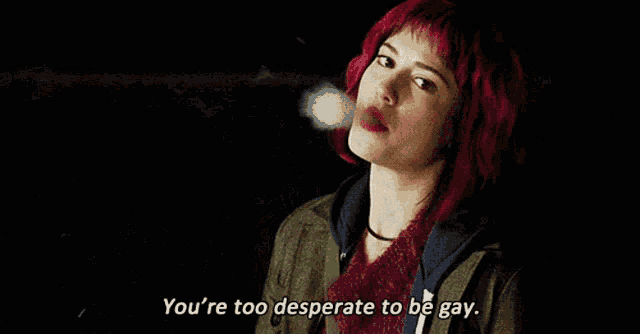 a woman with red hair is smoking a cigarette and says you 're too desperate to be gay