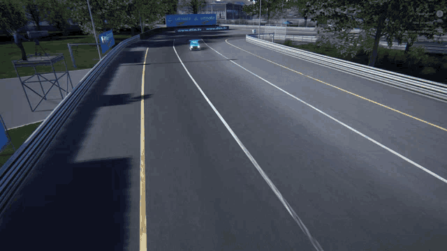 a blue race car is driving down a road with a sign that says telcel on it