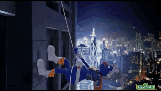 a sesame street character hanging from a rope