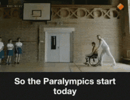a man in a wheelchair is being pushed by a man in a white shirt
