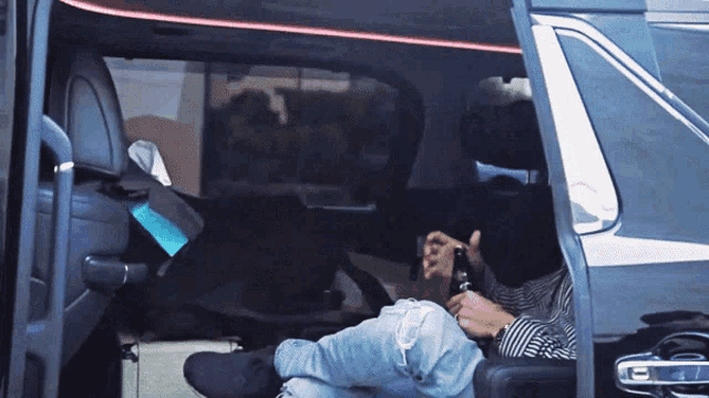 a man is sitting in the back seat of a car