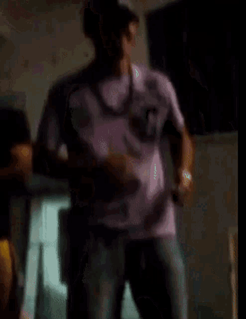 a blurry picture of a man standing in the dark