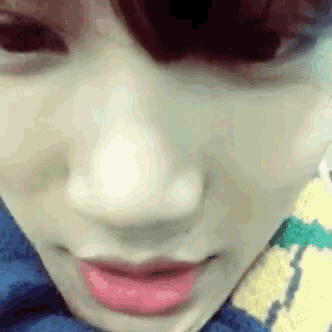 a close up of a person 's face with red lipstick on it .