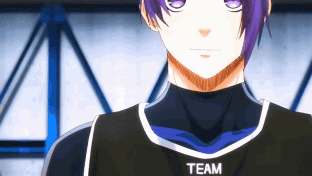 a close up of a person wearing a black shirt with the word team on it