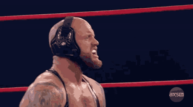 a wrestler in a ring with axstv written on the bottom