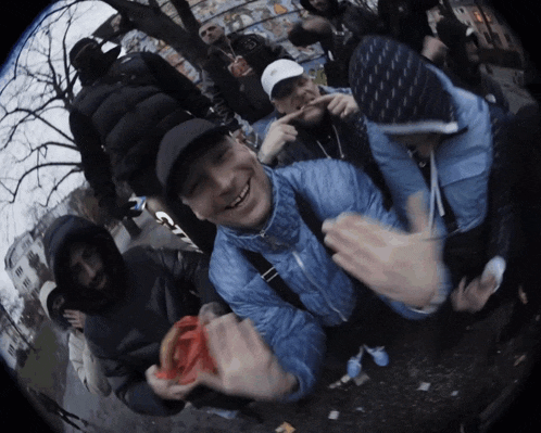a group of people are posing for a picture and one of them is wearing a blue jacket