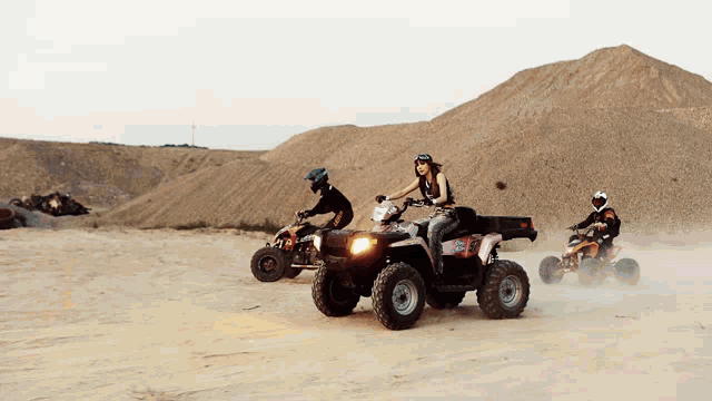 a woman is riding a polaris atv in the dirt