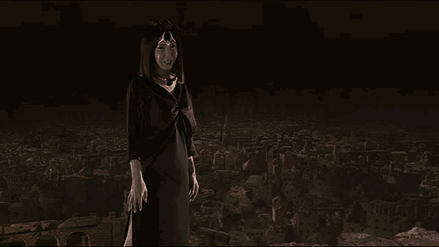 a woman in a black dress stands in front of a dark city