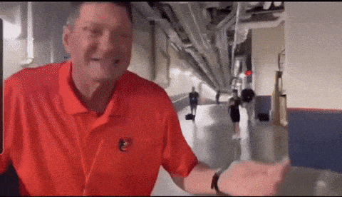 a man in a red shirt with a e on it