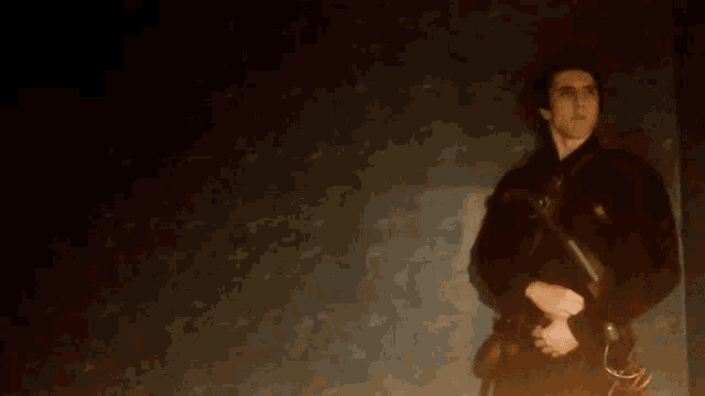a man is holding a sparkler in his right hand