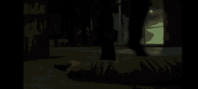a man is laying on the floor holding a gun