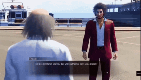 a man in a red suit talks to another man in a white shirt