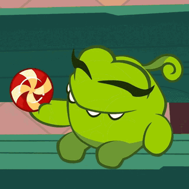 a green cartoon character is holding a red and white swirl lollipop