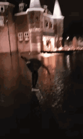 a blurry picture of a person in a flooded area at night
