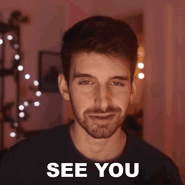 a man with a beard says see you in front of his face