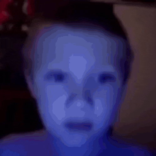 a close up of a child 's face with blue paint on it .