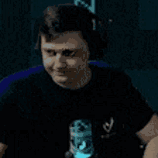 a man wearing headphones is sitting in front of a computer .
